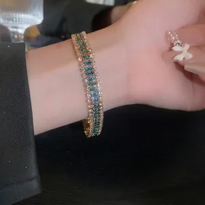Three-row rhinestone bracelet with blue square stones and gold metal base for women