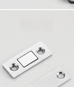 Close-up of galvanized magnetic door catch with dual screw holes for sliding cabinet doors