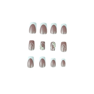 Short square press-on nails with white French tips, 3D floral accents and heart patterns