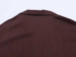 Detail of the chestnut blazer collar showing high-quality stitching and woven fabric texture
