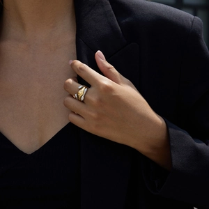 Macro detail of tri-layer hollow mixed metal ring with 18K gold and silver hammer texture