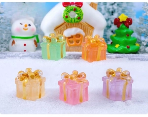 Detailed view of colorful miniature Christmas gift boxes set in a snow micro landscape