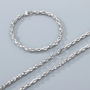 Macro shot of stainless steel pig nose chain necklace and bracelet set with lobster clasp