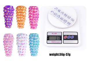 Detail view of colorful resin nail rhinestones set with weight scale showing 36g to 37g