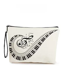 Close-up of canvas makeup bag showing piano keys and musical notes pattern and texture