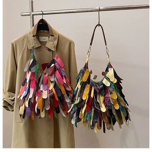 Close-up of bohemian fringed handbags featuring smooth and animal-embossed leather textures