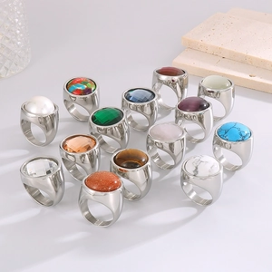 Detail view of various punk style 22mm gold and silver rings with multi-color gemstones