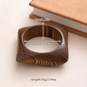 Detailed view of wide square wood bangle with size specs: 3cm width and 6.8cm inner diameter