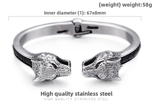 Close-up of vintage wolf head stainless steel bangle with black braided texture inlay