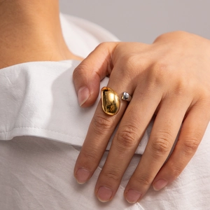 Irregular oval two-tone 18K gold plated stainless steel open ring worn on a finger