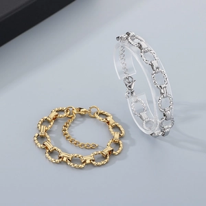 Detail view of gold and silver textured O-chain bracelets with adjustable lobster clasp