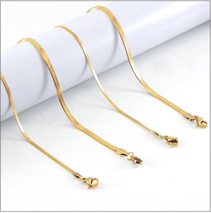 Detail of four 18K gold plated stainless steel flat snake chains with lobster clasps