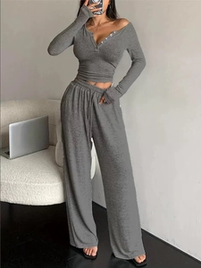Women's grey ribbed knit lounge set featuring V-neck button top and wide-leg trousers