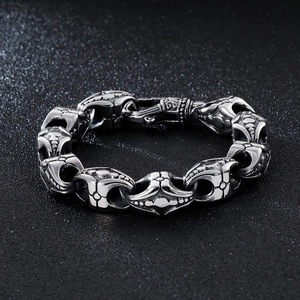 Detail of gothic stainless steel bracelet showing intricate cross floral carvings
