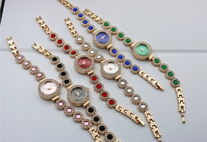 Elegant women's quartz watches with sparkling crystals and colorful dials in luxury gold