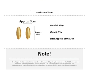 Detail view of large gold brushed oval earrings with 6cm by 3cm size dimensions