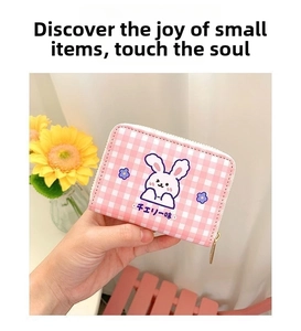 Close-up of pink checkered card holder with purple rabbit print and metal zipper detail