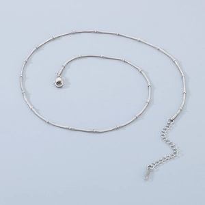 Detail of silver snake bone chain with small beads and adjustable lobster clasp finish