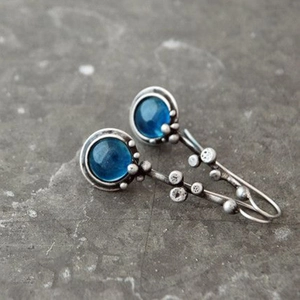 Boucles d'oreilles vintage en argent avec pierres de lune bleues sur fond de pierre