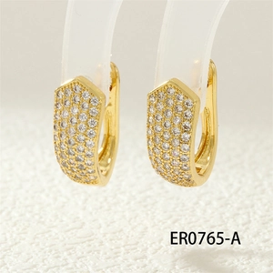 Detailed close-up of gold-plated U-shaped hoop earrings with pave-set clear zircon crystals