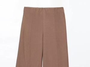 Detail of brown ribbed knit trousers showing soft vertical texture and elastic waistband