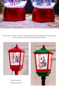 Detail of LED Christmas lanterns with snow globe scenes showing Santa and a cottage
