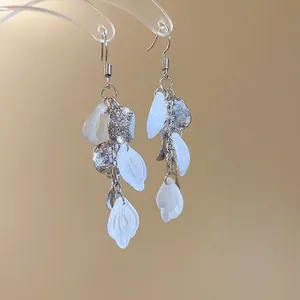 Elegant long tassel drop earrings with white flower petals and silver textured metal disks