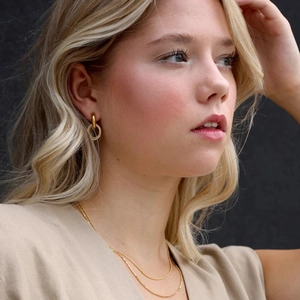 Close-up of 18K gold plated layered hoop earrings with zircon pendant and matching necklace