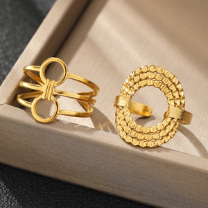 Macro detail of gold geometric stainless steel rings with concentric wavy textures