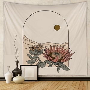 Detail of bohemian wall tapestry featuring sun, desert mountains and floral illustrations