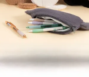Detail of grey plush cat pencil case with zipper and stationery inside a soft storage bag