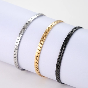 Detailed view of three square-link bracelets in gold, silver, and black finish