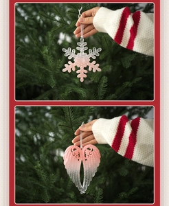 Detailed view of pink gradient snowflake and angel wing pendants held for size reference