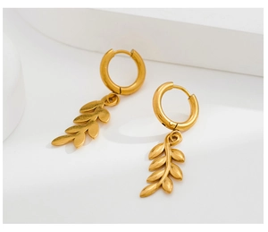 Detailed view of gold leaf pendant earrings featuring a classic hoop design and metal finish