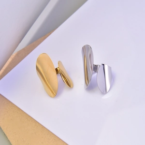 Detailed view of irregular minimalist open rings in polished gold and silver finishes