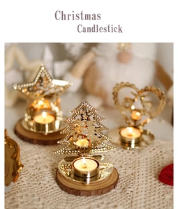 Golden iron Christmas candlesticks with star and tree shapes on wooden bases