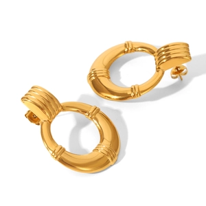 Detail of gold-colored chunky geometric round earrings with fine threaded texture finish
