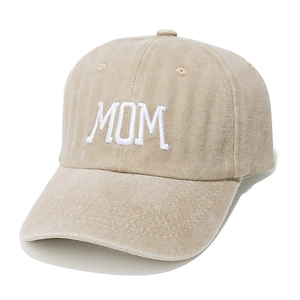 Close-up of MOM white embroidery on washed khaki cotton baseball cap with curved brim