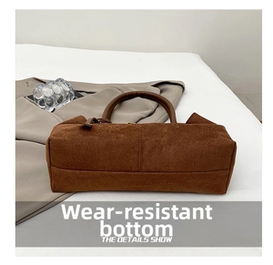 Macro view of the durable bottom base on this vintage brown suede tote handbag