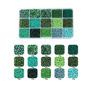 Macro detail of 15-compartment glass bead kit with green tone seed and bugle beads