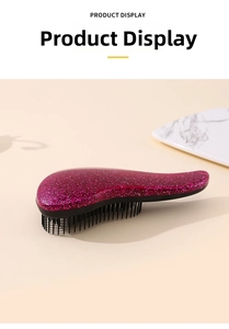 Macro detail of ergonomic detangling hairbrush with pink glitter finish and flexible bristles
