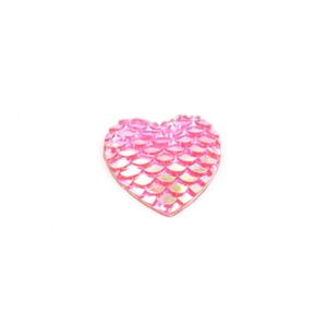 Macro shot of 16mm pink heart resin cabochon with realistic fish scale texture for DIY