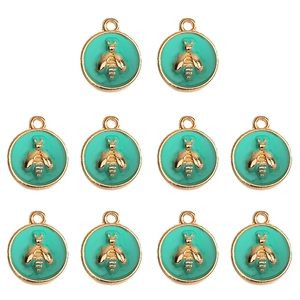 Detailed view of ten turquoise enamel round bee pendants with gold-plated alloy frames