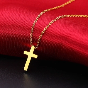 Classic 18K gold plated stainless steel cross pendant necklace on red silk background