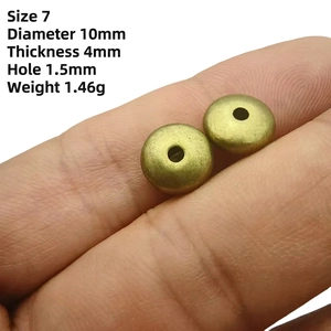Detail of 10mm antique bronze wheel spacer beads showing thickness and hole measurements