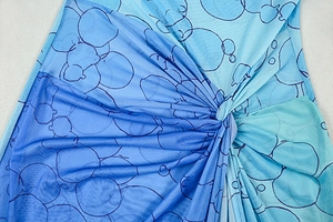 Detailed close-up of blue gradient mesh fabric with twist knot and abstract pattern