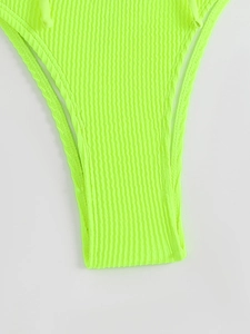 Detail view of neon green ribbed fabric and high cut stitch work of this beach swimwear