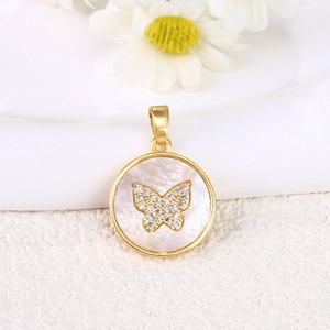 Detailed view of a gold circular pendant with white mother-of-pearl and diamond butterfly