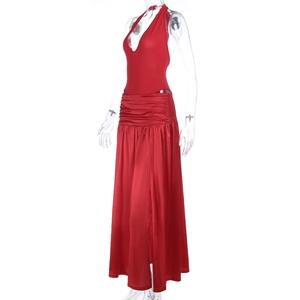Detail of red satin halter bodysuit and high waist draped slit skirt on mannequin