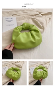 Close-up of bright green knotted dumpling handbag with premium soft lychee texture